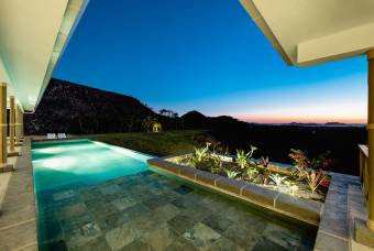 Luxury villa with pool and views of nature, valley and sea.